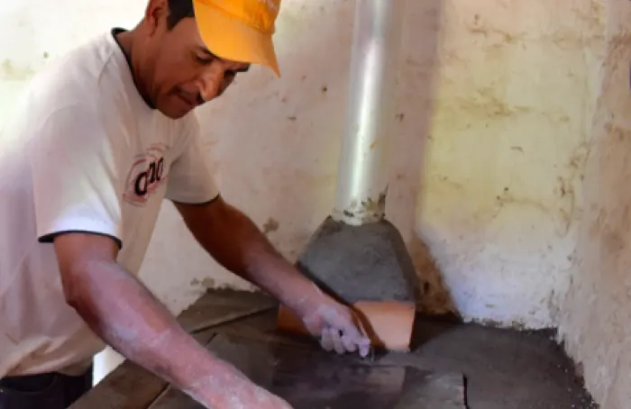 person working on cookstove