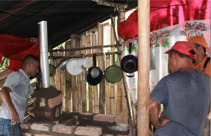 3 people near cookstoves and pans